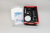 The picture shows an experiment set called &quot;Optics 2.0&quot;, consisting of various optical components organized in a red container with foam insert. In addition, there is an instruction manual with information on how to use and carry out the experiment. 