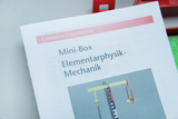 The image shows instructions for a mini box intended for experiments in elementary physics and mechanics. The page shows an experimental setup with various components to illustrate physical concepts.