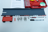 The picture shows an arrangement of experimental materials, including a gray rail, a red vehicle, various hooks and weights, and a textbook with instructions. These materials are designed for educational experiments to develop physical