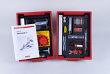 The picture shows an experiment set for students entitled &quot;Mechanics 1&quot;, which is housed in a red box. It contains various materials and tools that can be used for practical experiments in the field of mechanics.