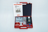 The picture shows a red box with experimental materials for elementary physics and electricity, including various electrical components and an educational booklet. The box is clearly arranged to enable students to carry out practical experiments.