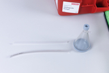The picture shows scientific equipment from a biology classroom set, including a funnel and two transparent tubes. These materials are designed for experiments in the German educational system.