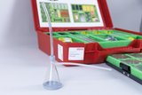 The picture shows an experimental device in the form of a funnel with a tube, which is placed in a red case for biological equipment. The case contains various laboratory utensils that can be used for experiments in the educational field.