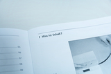The picture shows an open page of a book with the title &quot;What is sound?&quot;. There is also an illustration that is probably related to experimenting with sound phenomena.