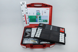 The picture shows a red toolbox filled with various experimental materials for educational purposes. It contains, among other things, sample tubes, glasses, pipettes and an overview card with the materials included.