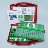 The picture shows a red case set for experiments in the field of electrical engineering, which contains various components and materials for carrying out electrical circuit projects. There is also an instruction manual that explains design options and experiments.