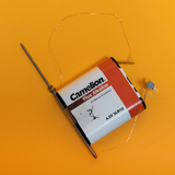 The picture shows a Camelion brand 4.5V alkaline battery combined with a metal pin and other wire connections. This arrangement could be used for simple electrical experiments or educational circuit projects.