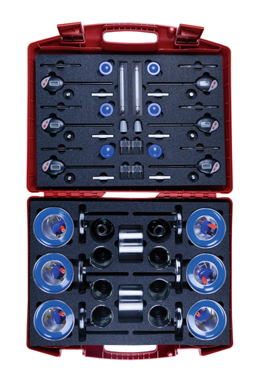 The image shows a red suitcase equipped with various educational experiment materials. The arrangement includes measuring instruments, containers, and accessories that can be used for physical or chemical experiments.