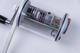 The image shows a transparent device with an electric motor and gearbox, designed for experimental purposes. It features a bracket and various connecting wires required for operation and assembly.