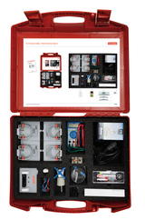 The picture shows a red box containing an experiment set on photovoltaics. The set contains various components such as solar cells, measuring devices, cables and other accessories that can be used for practical experiments in the educational sector.