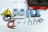 The image shows equipment and accessories for electrical engineering experiments, including transformers, cables and various components. A high voltage warning is also included, indicating the dangers of handling these materials.