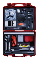 The picture shows a red suitcase filled with various experimental materials for educational purposes. The materials include measuring instruments, models and experimental utensils suitable for scientific teaching purposes.