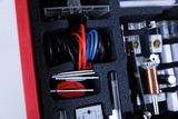 The picture shows a collection of experimental materials in a well-organized case. You can see various cables, components and devices that can be used for scientific experiments in the educational field.