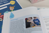 The picture shows a page from a textbook on the subject of water, designed for experiments in education. The illustration shows two children working with an experimental device while methodical instructions are given on how to carry out water experiments.