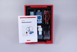 The picture shows a set of equipment for conducting electrochemical experiments, consisting of a measuring device, cables and various reagents. A manual with instructions for the experiment is also included.