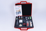 The picture shows a red suitcase set for experiments in education, which contains various materials such as containers, pipettes, a magnifying glass and scissors. In addition, an instruction manual entitled &quot;Paths into the world of the small&quot; is visible in the suitcase.