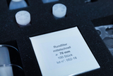 The picture shows a set of round filters with a diameter of 70 mm, laid out in a dark foam. The packaging contains 100 pieces and is provided with a product description.