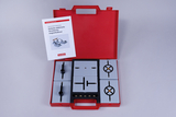 The picture shows a red case with a set for simple electrical circuits, which is specially designed for educational purposes. Inside there are several components such as switches and connections, as well as instructions for carrying out experiments.