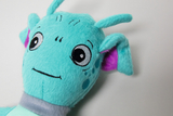 The picture shows a cute, turquoise stuffed animal with big eyes and a friendly expression. It also has purple ears that give it a playful look and is well suited for educational purposes or as a companion for experiments.