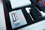The picture shows a case with experimental materials designed for educational purposes. It contains various components such as a battery holder and connecting cables that can be used for scientific experiments.