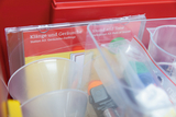 The image shows a section of an educational experiment kit containing materials for exploring sounds and noises. The packaging features the titles &quot;Sound and Tone&quot; along with transparent containers and utensils.