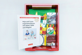 The picture shows a red box with experimental materials and an accompanying book for kindergarten children. The materials include various objects for experiments on topics such as levers, pulleys and magnetism, which invite learning and discovery.