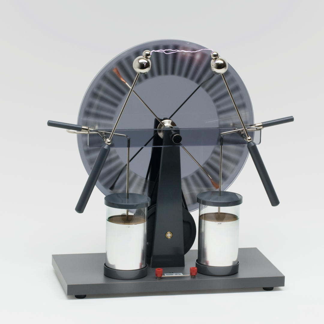 The picture shows an electrostatic device used to conduct experiments in education. It has a rotating disk and two glass bulbs that are used to generate and demonstrate electrical charge.