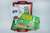 The picture shows a red experiment kit equipped with various measuring instruments, including thermometers, measuring bowls and various metrics. There is also an instruction manual included to help students measure temperatures, weights and lengths.