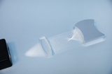 The image shows a transparent optical element that interacts with a light beam and refracts or reflects light rays. It is placed in an experimental setup designed for educational purposes.