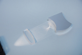 The picture shows an optical experimental device consisting of two transparent elements that refract or direct light. The light beam is sent through the materials, making various light phenomena visible.