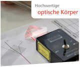 The picture shows a high-quality optical lens in the form of a prism through which a red laser beam is projected. Next to it is an experimental device and a worksheet with diagrams and lines for investigating light refraction and reflection.