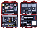 The picture shows a red toolbox filled with various experimental materials for educational purposes. The compartments contain measuring instruments, accessories, pipettes and mechanical components that can be used for scientific experiments.