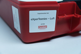 The picture shows a red experiment set entitled &quot;eXperTeenies - Air&quot; by Cornelsen Experimenta. It is a set for scientific experiments that is specially designed for education in the field of air and its properties.