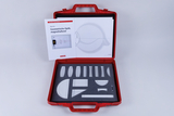 The picture shows a red medical set for geometric optics, which contains various optical elements on a padded base. In addition, instructions for experiments in optics are included to promote the understanding of light and lenses.