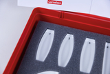 The picture shows a red box with a foam insert in which several transparent sample containers with numbers from 1 to 4 are lined up. The Cornelsen logo is visible at the top, indicating that the company is a supplier of educational supplies.