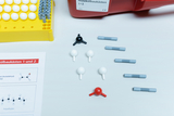 The image shows a molecular building kit with different colorful pieces representing atoms and bonds. There is also a worksheet that contains information about chemical structures such as acetaldehyde and polyethylene.