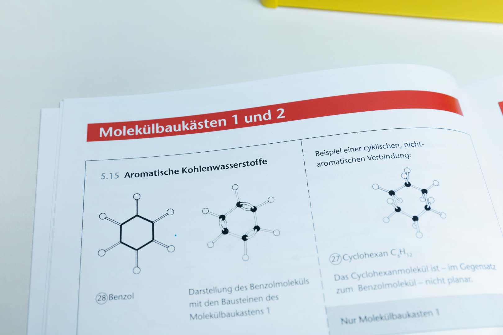 The picture shows pages from a molecular modeling textbook dealing with aromatic and non-aromatic hydrocarbons. Molecular structures of benzene and cyclohexane are shown, with explanations of their properties.