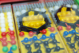 The picture shows various colored building blocks and connectors designed for educational experiments. The elements are arranged in rows and housed in a transparent container for easy use.