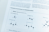 The picture shows a page from a textbook that includes examples of alkanes and their structural formulas. Among others, methane, ethane, propane, n-butane and i-butane are shown with corresponding chemical formulas and molecular models.