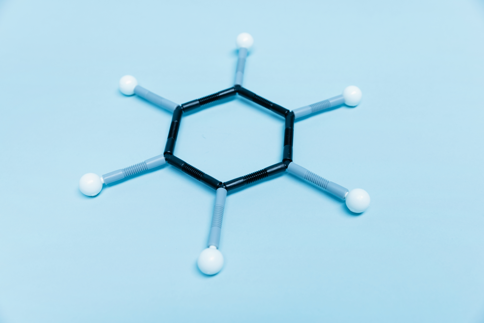 The image shows a model of a molecule consisting of connected balls and rods. It is placed on a light blue background and is suitable for illustrating chemical structures in education.