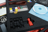The picture shows an experiment kit that contains various materials for teaching, including colored cubes, a red and white layer, CD disks, and a metal bowl. These supplies are neatly arranged in a foam insert to protect and organize them.