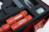 The picture shows a sturdily packaged set with two red flashlights and other experimental materials in a foam insert. The arrangement in the red case suggests that this is a set for educational purposes.