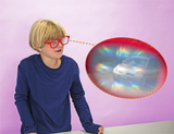 The picture shows a boy wearing red glasses and looking at a blurry picture of a car. In a speech bubble, colored light reflections can be seen, indicating an exciting perception.