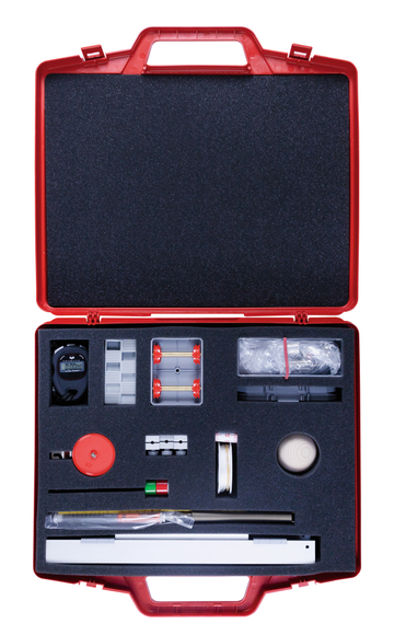 The picture shows a red plastic case containing a classroom experiment kit. The box contains various tools and materials, including a stopwatch, a slide, and other items for scientific experiments.