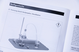 The image shows instructions for performing a distillation, including a picture of the equipment needed such as a hot plate, an Erlenmeyer flask and a condenser. The information is part of an educational textbook on mixtures of substances.