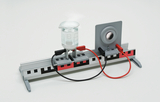 The picture shows an experimental device consisting of a beaker, electrical connecting cables and an experimental circuit board. It is used to carry out physical or chemical experiments in the educational field.