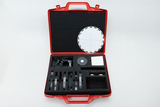 The picture shows an open red suitcase filled with various experimental materials. Inside there is a round disc with markings, various transparent plates and other accessories for scientific experiments.