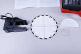 The picture shows a collection of experimental materials, including a mechanical holder, a round scale with graduations, and various optical elements such as lenses. These materials are designed for use in educational projects to investigate physical phenomena.