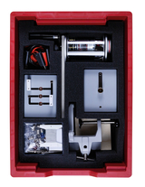 The picture shows an experiment kit arranged in a red container. It contains various technical components, including a motor, cables, brackets and other accessories for educational projects.