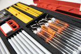 The picture shows a well-sorted experiment kit containing various laboratory equipment such as glass flasks, measuring instruments and tools. The careful arrangement in a sturdy case allows for easy handling and organization for educational purposes.